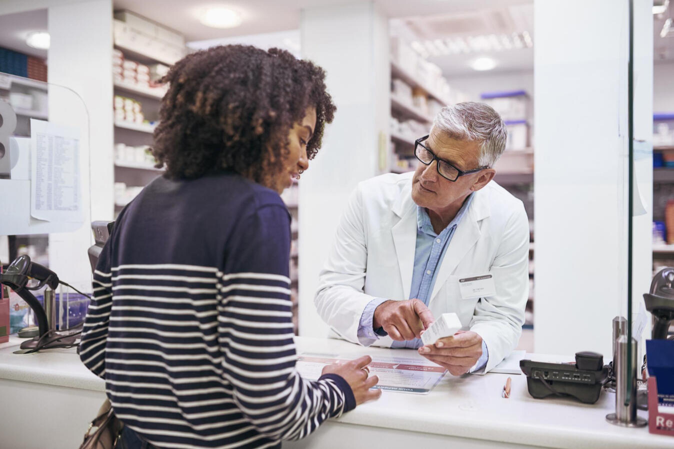 Pharamacist talking to her patient